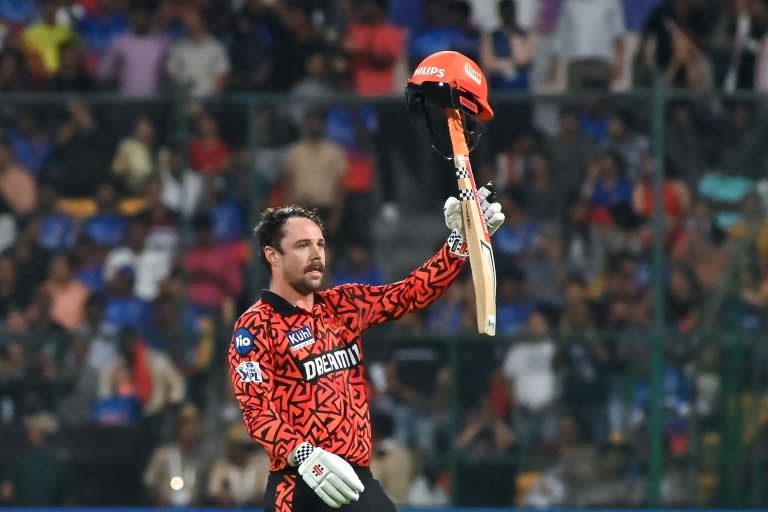 Hats off! Travis Head celebrates his 39-ball century for Sunrisers Hyderabad in their record 287-3 against Royal Challengers Bengaluru on Monday (-)