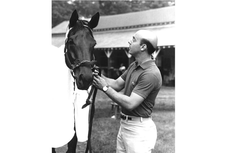 This undated photo, provided by the National Museum of Racing and Hall of Fame, shows trainer John Veitch with Davona Dale. Veitch, who trained Alydar to narrow losses in all three Triple Crown races against rival Affirmed in 1978 during a Hall of Fame career, has died. He was 77. He died Tuesday, Feb. 14, 2023, of natural causes at home in Lexington, KY. (National Museum of Racing and Hall of Fame via AP)