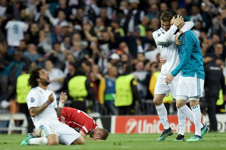 <a class="link " href="https://sports.yahoo.com/soccer/teams/real-madrid/" data-i13n="sec:content-canvas;subsec:anchor_text;elm:context_link" data-ylk="slk:Real Madrid;sec:content-canvas;subsec:anchor_text;elm:context_link;itc:0">Real Madrid</a>'s Marcelo (L), Cristiano Ronaldo and Karim Benzema (R) celebrate after eliminating <a class="link " href="https://sports.yahoo.com/soccer/teams/bayern-munich/" data-i13n="sec:content-canvas;subsec:anchor_text;elm:context_link" data-ylk="slk:Bayern Munich;sec:content-canvas;subsec:anchor_text;elm:context_link;itc:0">Bayern Munich</a> in the 2018 Champions League semi-final (OSCAR DEL POZO)