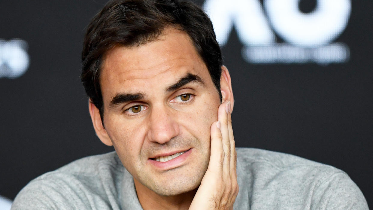 Roger Federer looks tired as he speaks during his post match press conference.
