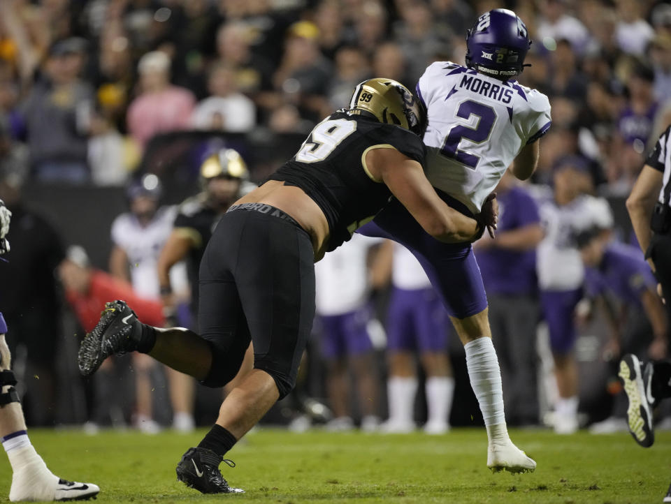 Colorado defensive lineman Jalen Sami, left, hits TCU quarterback Chandler Morris after he passed the ball in the second half of an NCAA college football game Friday, Sept. 2, 2022, in Boulder, Colo. Morris left the game with a leg injury after the play. (AP Photo/David Zalubowski)