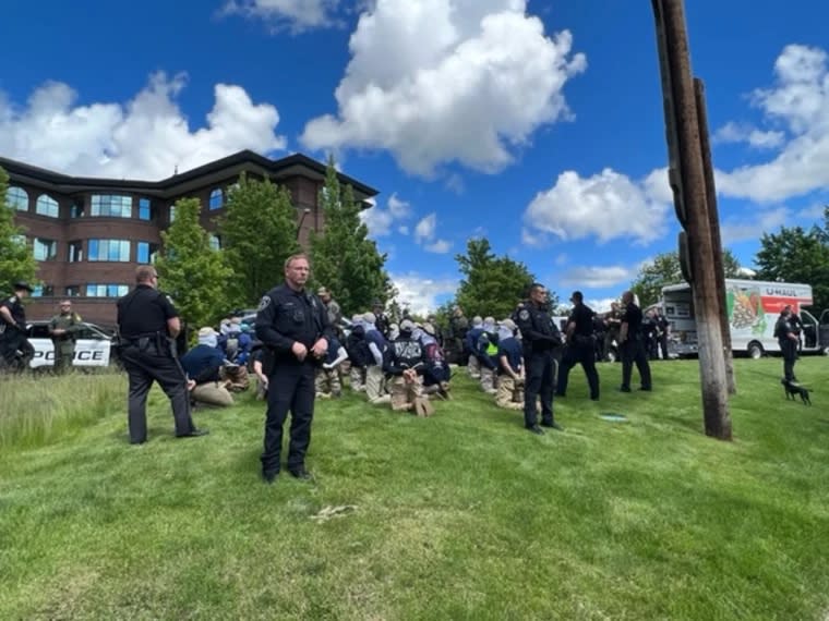 Police in Coeur d'Alene, Idaho, detain people pulled Saturday, June. 11, 2022, from a U-Haul truck near the city's Pride celebration. (Georji Brown)