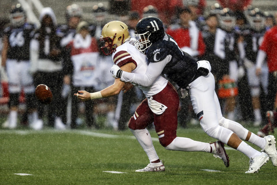 Boston College quarterback Dennis Grosel (6) fumbles the ball as he is tackled by Cincinnati linebacker Bryan Wright (11) during the first half of the Birmingham Bowl NCAA college football game Thursday, Jan. 2, 2020, in Birmingham, Ala. (Photo/Butch Dill)