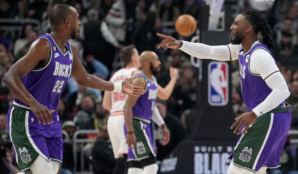 Milwaukee Bucks forward Jae Crowder (99) signals to forward Khris Middleton (22) after hitting a three-point basket during the first half of their game Friday, February 43, 2023 at Fiserv Forum in Milwaukee Wis.