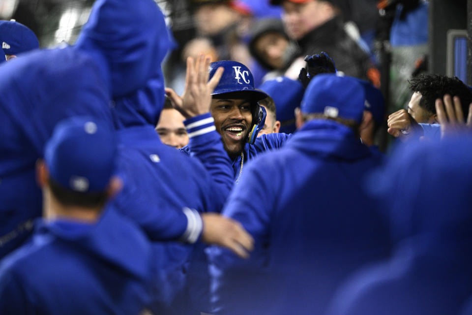 Kansas City Royals' Maikel Garcia, center, is congratulated in the dugout after a home run against the Baltimore Orioles during the seventh inning of a baseball game Wednesday, April 3, 2024, in Baltimore. (AP Photo/Nick Wass)