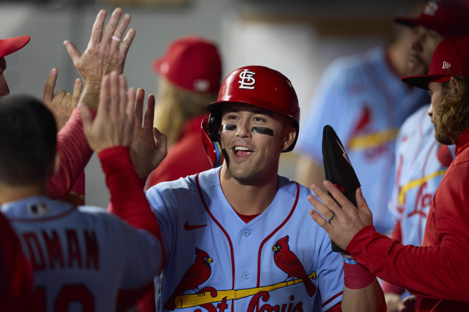 St. Louis Cardinals right fielder Lars Nootbaar is congratulated in the dugout after scoring on a single by Nolan Arenado against the Seattle Mariners during the first inning of a baseball game Saturday, April 22, 2023, in Seattle. AP Photo/John Froschauer)