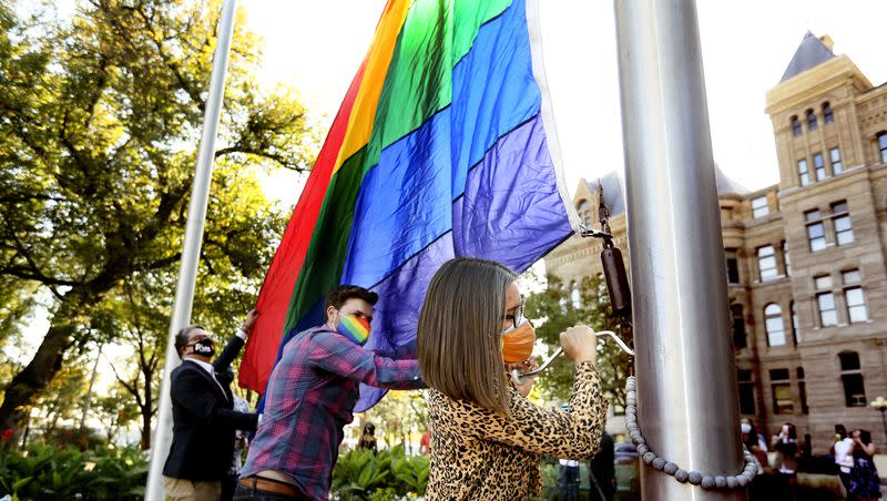 Salt Lake City Mayor Erin Mendenhall raises the pride flag with Salt Lake City Council member Chris Wharton and Utah Pride Center Executive Director Rob Moolman at the City-County Building in Salt Lake City on Oct. 9, 2020.