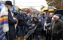 A Shabbat morning service led by former Tree of Life rabbi Chuck Diamond,center, is held outside the Tree of Life Synagogue Saturday, Nov. 3, 2018 in Pittsburgh. About 100 people gathered in a cold drizzle for what was called a "healing service" outside the synagogue that was the scene of a mass shooting a week ago. (AP Photo/Gene J. Puskar)