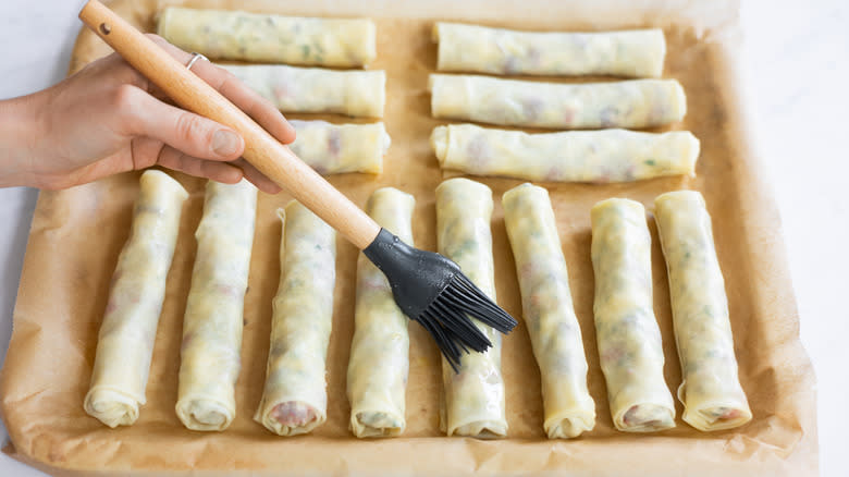 brushing the cigars with the melted butter 