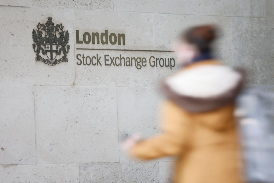 A pedestrian walks past the logo for the London Stock Exchange Group outside the stock exchange in London on December 29, 2020. - The London stock market soared on December 29 as investors gave their initial verdict on Britain's Brexit deal with the EU, while eurozone equities also rose on upbeat US stimulus news, with Frankfurt extending its record breaking run. (Photo by Tolga Akmen / AFP) (Photo by TOLGA AKMEN/AFP via Getty Images)