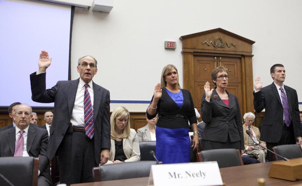 Witnesses of sworn in on Capitol Hill in Washington, Tuesday, April 17, 2012, prior to testifying before a House Transportation subcommittee hearing to investigate an excessive conference at a Las Vegas resort by General Services Administration officials in 2010. From left are, former GSA Public Buildings Service Commissioner Robert Peck, suspended GSA Public Buildings Service event planner Lisa Daniels, Martha Johnson, who stepped down as GSA administrator because of the scandal, and David Foley, deputy commissioner of the GSA Public Buildings Service. (AP Photo/J. Scott Applewhite)