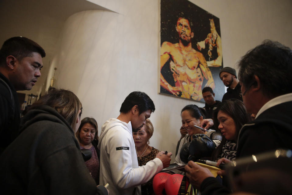 Boxer Manny Pacquiao is surrounded by guests at his home Monday, Jan. 14, 2019, in Los Angeles. The Filipino legend is in the winter of his career, gearing up for what could be one big last fight. Saturday's bout versus Broner isn't it, but Pacquiao trains with the knowledge that a second megafight against Floyd Mayweather could possibly be just months away if all goes well. (AP Photo/Jae C. Hong)