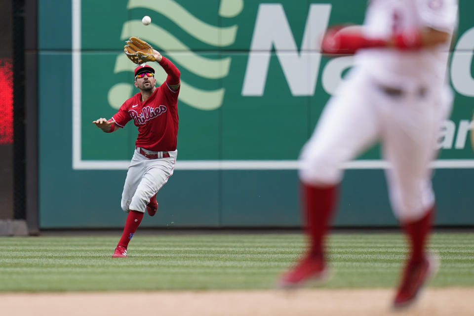 Philadelphia Phillies right fielder Nick Castellanos catches a fly ball that was hit by Washington Nationals' Keibert Ruiz to end the sixth inning of the first game of a baseball doubleheader, Friday, June 17, 2022, in Washington. (AP Photo/Patrick Semansky)