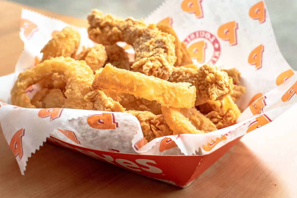 CANADA, TORONTO, ONTARIO - 2018/12/20: Popeyes real food: five chicken tenders with onion rings. Backlit image. (Photo by Roberto Machado Noa/LightRocket via Getty Images)