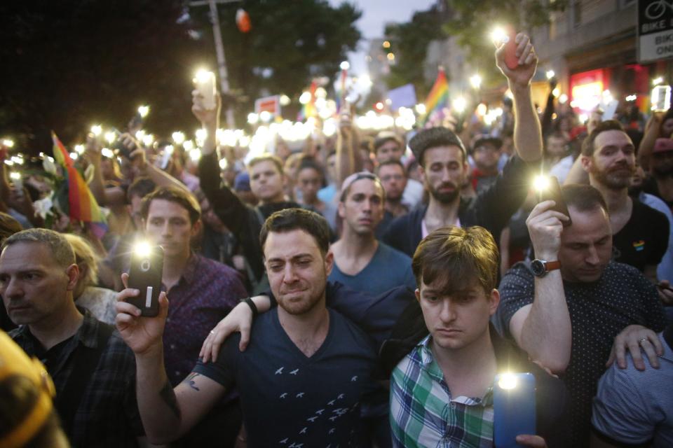 People hold candels and lights during a vigil in solidarity outside Manhattan's historic Stonewall Inn to express their support for the victims killed at Pulse nightclub in Orlando in New York on June 13 ,2016.&nbsp;