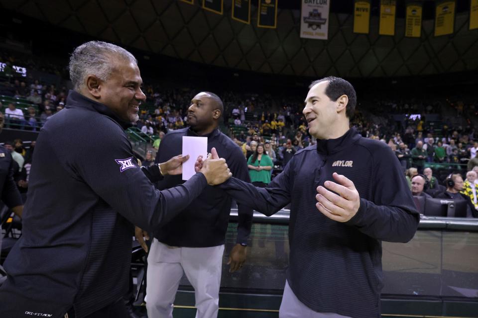 Kansas State coach Jerome Tang, left, shakes hands with Baylor coach Scott Drew before Saturday's game at Ferrell Center in Waco, Texas. K-State and Tang beat his former boss, 97-95, in overtime.