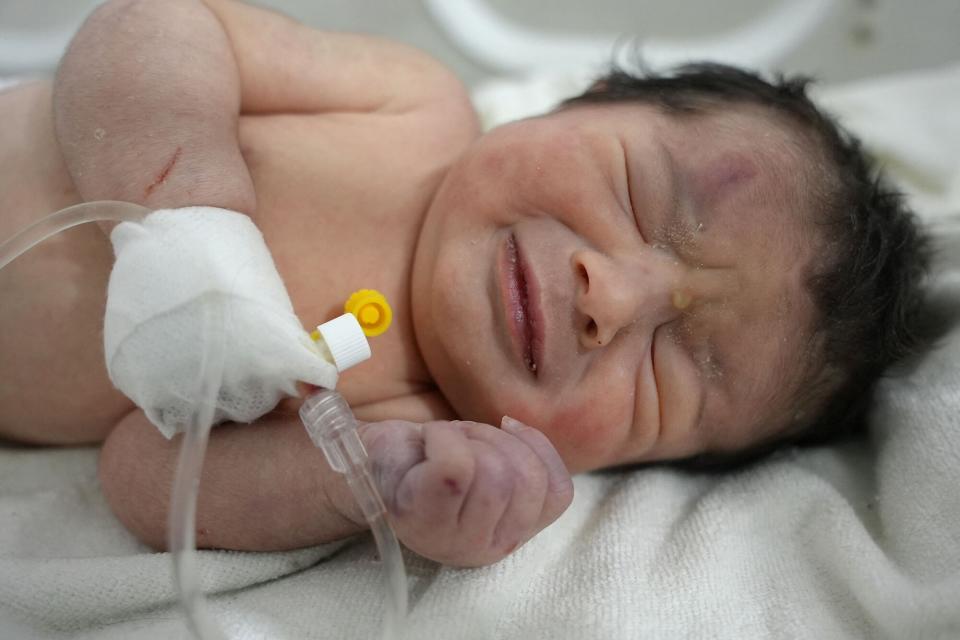 A newborn baby who was found still tied by her umbilical cord to her mother and pulled alive from the rubble of a home in northern Syria following a deadly earthquake, receives medical care at a clinic in Afrin, on February 7, 2023. - The infant is the sole survivor of her immediate family, the rest of whom were all killed when a 7.8-magnitude quake that struck Syria and neighbouring Turkey flattened the family home in the rebel-held town of Jindayris, cousin Khalil al-Suwadi said.