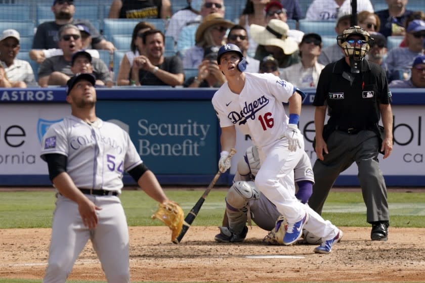 Los Angeles Dodgers' Will Smith, center, runs to first after hitting a solo home run as Colorado Rockies relief pitcher Carlos Estevez, left, watches along with home plate umpire Jerry Meals during the eighth inning of a baseball game Sunday, July 25, 2021, in Los Angeles. (AP Photo/Mark J. Terrill)