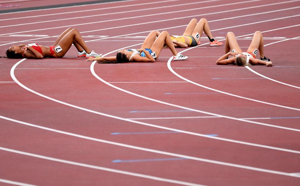 Women from the heptathlon try to catch their breath after completing the 800m.