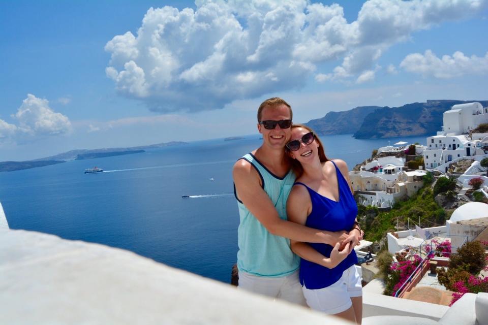 woman and man posing in front of sea