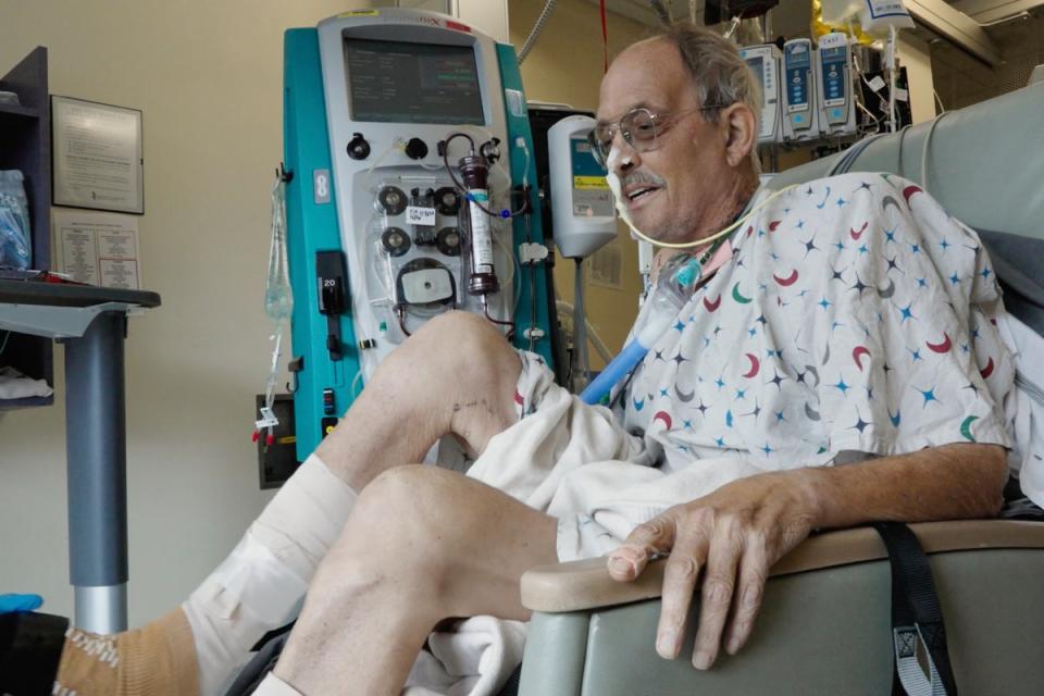 Lawrence Faucette working with a physical therapist (AP)