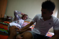 Muay Thai boxer Nong Rose Baan Charoensuk, 21, who is transgender, spends times with her boyfriend Beer at the Baan Charoensuk gym in Chachoengsao province, Thailand, July 12, 2017. REUTERS/Athit Perawongmetha