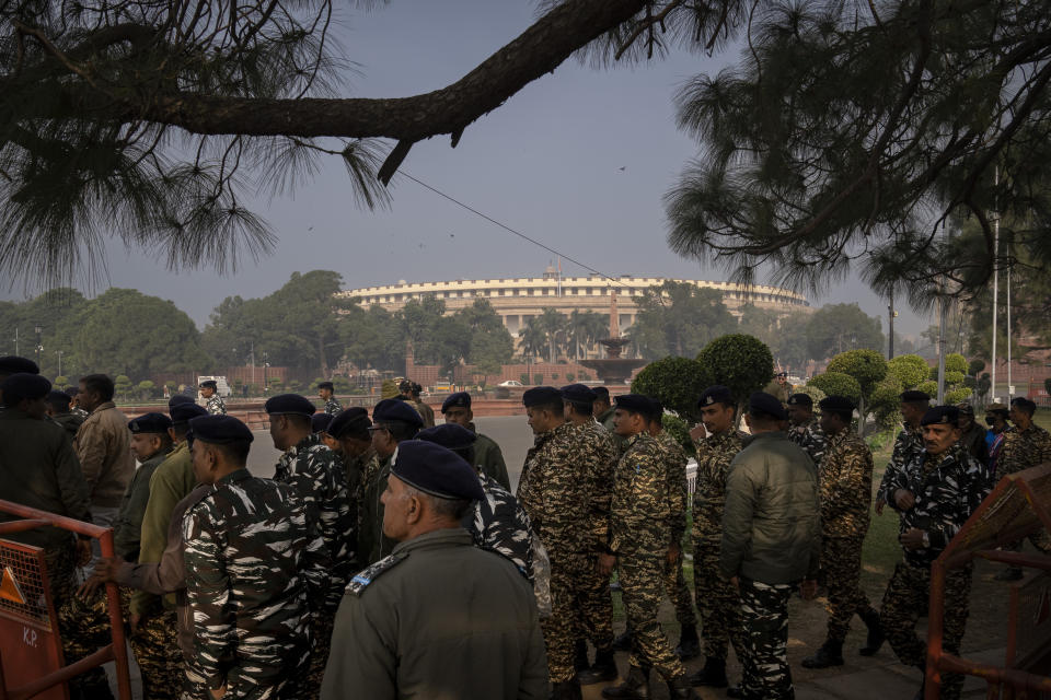 Indian paramilitary soldiers stand behind a barricade to prevent suspended lawmakers from marching ahead, outside the Parliament House in New Delhi, India, Thursday, Dec. 21, 2023. Dozens of opposition lawmakers suspended from Parliament by Prime Minister Narendra Modi's government for obstructing proceedings in the chamber held a street protest on Thursday accusing the government of throttling democracy in the country. (AP Photo/Altaf Qadri)