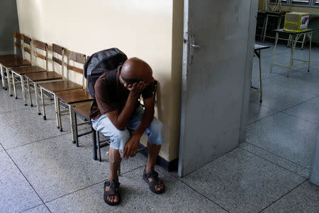 A man waits to vote at a polling station during the municipal legislators election in Caracas, Venezuela December 9, 2018. REUTERS/Marco Bello