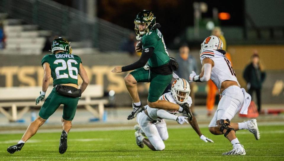 Sacramento State Hornets quarterback Carson Conklin (17) jumps over an = Idaho State defender in the second half at Hornet Stadium on Saturday. Conklin led the Hornets to a 51-16 victory against the Idaho State Bengals.