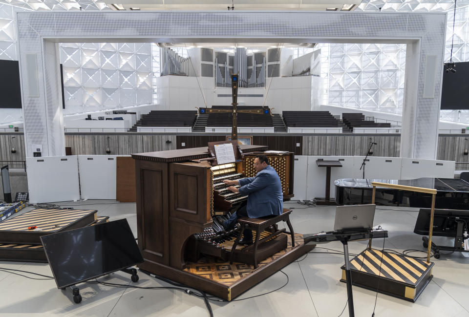 David La'O Ball, organist and head of music ministry at Christ Cathedral, plays the Hazel Wright organ in Garden Grove, Calif., Tuesday, Feb. 15, 2022. The Hazel Wright organ, named after its original benefactor, now has 17,000 pipes, 15 divisions and 293 ranks. Ball said it is the largest pipe organ in a Roman Catholic cathedral in the Western Hemisphere. (AP Photo/Damian Dovarganes)