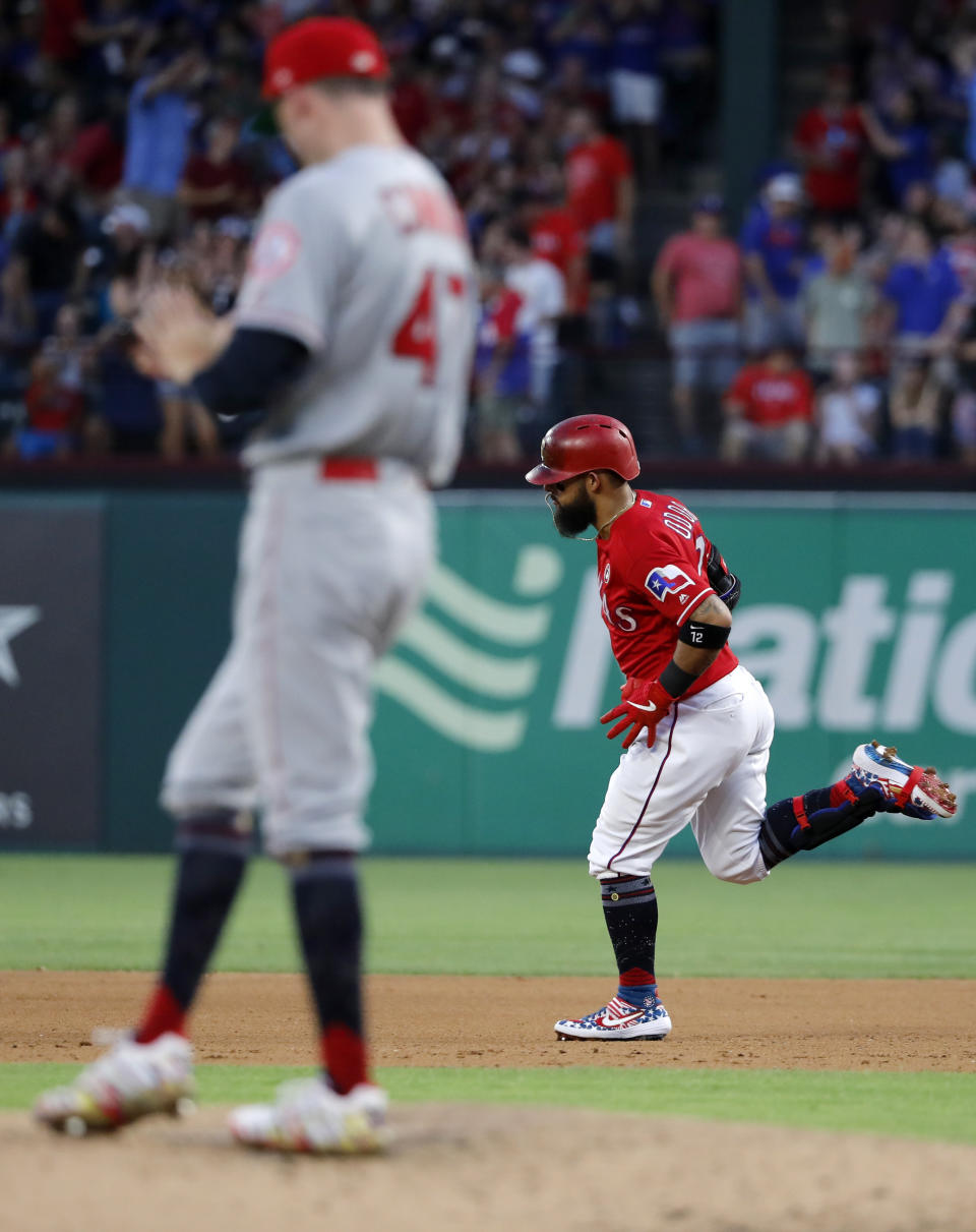 Los Angeles Angels starting pitcher Griffin Canning (47) stands on the mound as Texas Rangers' Rougned Odor (12) rounds the bases after hitting a two-run home run during the fourth inning of a baseball game in Arlington, Texas, Thursday, July 4, 2019. (AP Photo/Tony Gutierrez)