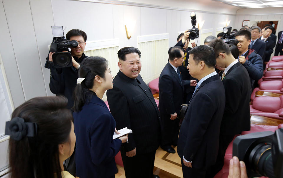 Kim Jong Un is seen meeting officials inside the train (AFP)