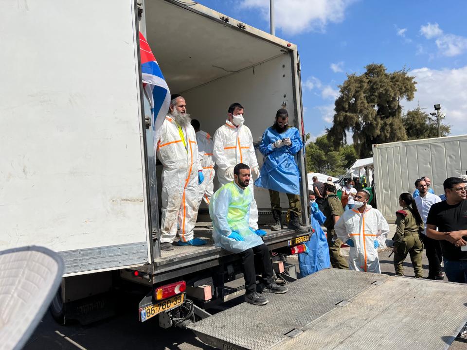 ZAKA volunteers stand in a truck used to transport victims of Hamas' attack on Israel.