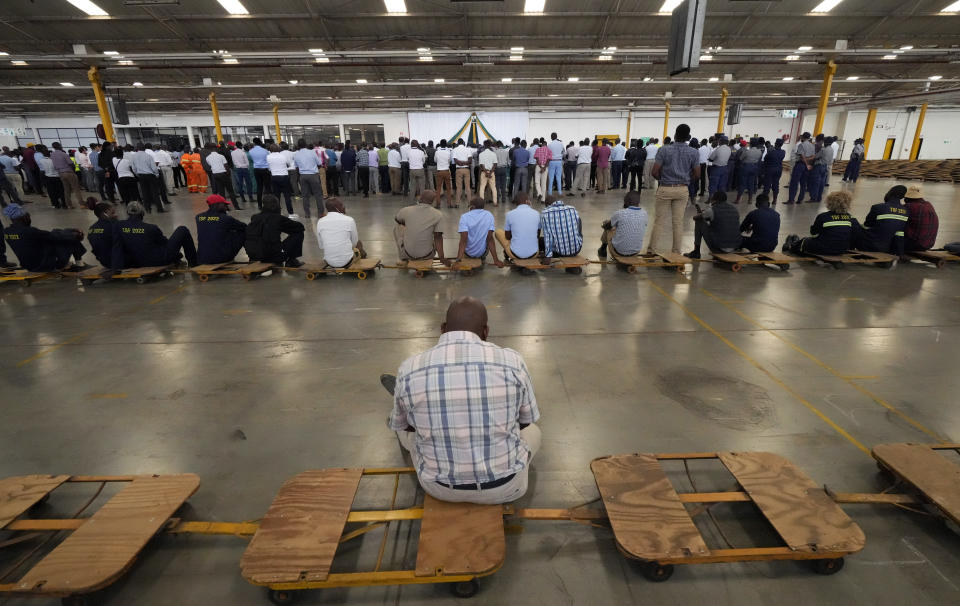 Workers and officials attend the official opening of the tobacco marketing season in Harare, Zimbabwe, Wednesday, March, 8, 2023. Zimbabwe's tobacco is expected to increase following good rains as more farmers have planted this crop. Tobacco is one of the biggest export earners in the Southern African country. (AP Photo/Tsvangirayi Mukwazhi)