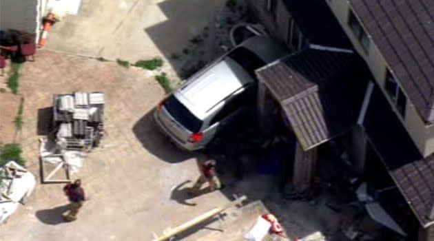 45-year-old woman suffers possible leg injuries after slamming her car into a house at Meadow Heights. Photo: 7News