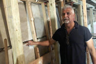 Sahadeo Bhagwandin shows a wide crack in the wall of his basement, in the Queens borough of New York, Friday, Sept. 17, 2021. Floodwaters surrounded his home after remnants of Hurricane Ida swept through the northeast, turning streets into torrent streams. It will takes tens of thousands of dollars to fix the buckled foundation. Without flood insurance, he is now trying to figure out how he will pay for expensive repairs. (AP Photo/Bobby Caina Calvan)