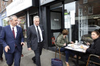 Democratic Unionist Party members Edwin Poot, left, and Ian Paisley jnr leave the party headquarters in east Belfast after voting took place to elect a new leader on Friday May 14, 2021. Edwin Poots and Jeffrey Donaldson are running to replace Arlene Foster. (AP Photo/Peter Morrison)