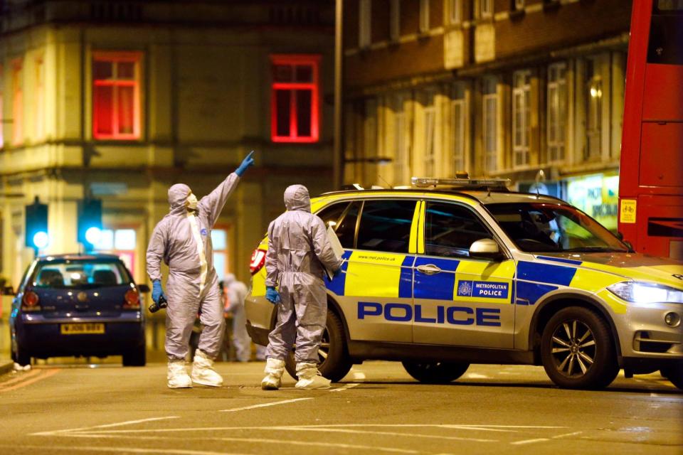 Forensic officers examine the scene where a man was shot and killed by armed police (Getty Images)