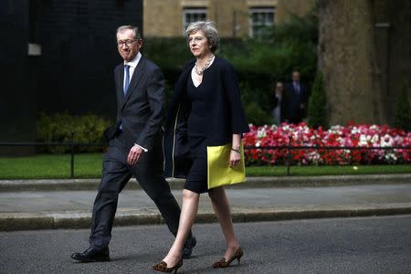 Britain's Prime Minister, Theresa May, and husband Philip walk up Downing Street, in central London, Britain July 13, 2016. REUTERS/Peter Nicholls