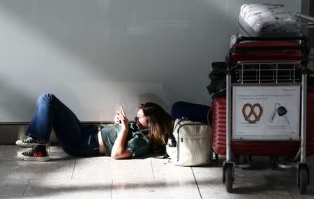 A woman waits with her luggage at Heathrow Terminal 5 in London, Britain May 27, 2017. REUTERS/Neil Hall