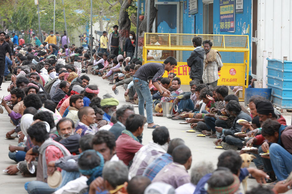 Homeless and impoverished Indians receive food at a government shelter in New Delhi, India, Thursday, March 26, 2020. Some of India's legions of poor and people suddenly thrown out of work by a nationwide stay-at-home order began receiving aid distribution Thursday, as both the public and private sector work to blunt the impact of efforts to curb the coronavirus pandemic. (AP Photo)