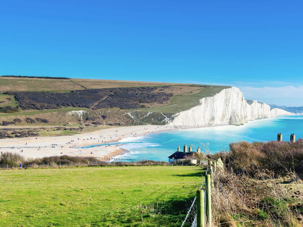 Soak up the views of the white chalk cliffs while walking down to Cuckmere Haven Beach (Getty Images/iStockphoto)