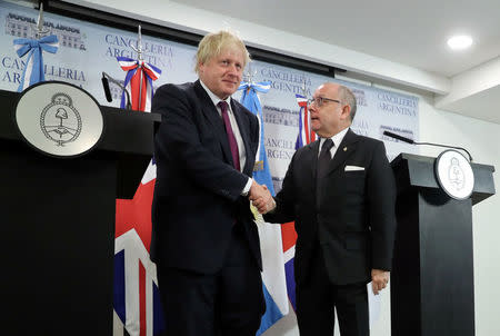 Britain's Foreign Secretary Boris Johnson and Argentina's Foreign Minister Jorge Faurie shake hands during a news conference in Buenos Aires, Argentina, May 22, 2018. REUTERS/Marcos Brindicci