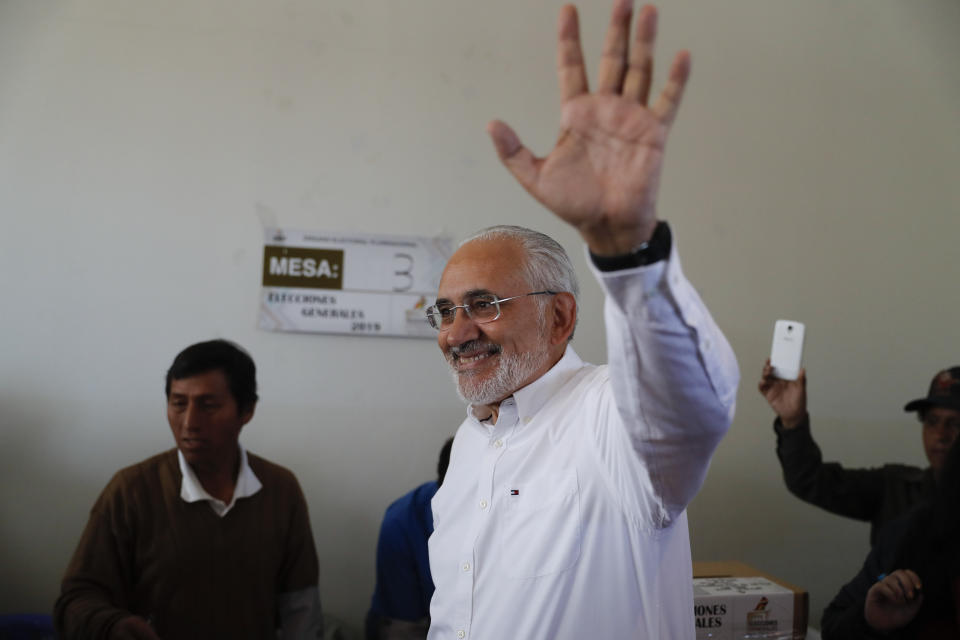 Opposition presidential candidate Carlos Mesa waves before voting during general elections in Mallasilla, in the outskirts of La Paz, Bolivia, Sunday, Oct. 20, 2019. Former president Mesa is the closest rival to President Evo Morales, who is seeking a fourth term in the country's general elections. (AP Photo/Jorge Saenz)