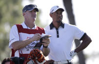 Golfer Tiger Woods, right, and his caddie Joe LaCava look over the course on the fourth tee during the Pro-Am round of the Honda Classic golf tournament, Wednesday, Feb. 26, 2014 in Palm Beach Gardens, Fla. (AP Photo/Wilfredo Lee)