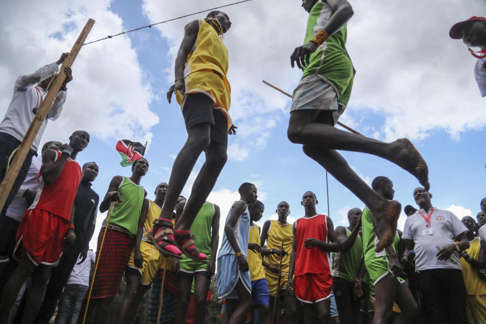 Maasai men compete in the high-jump competition at the Maasai Olympics in Kimana Sanctuary, southern Kenya Saturday, Dec. 10, 2022. The sports event, first held in 2012, consists of six track-and-field events based on traditional warrior skills and was created as an alternative to lion-killing as a rite of passage. (AP Photo/Brian Inganga)