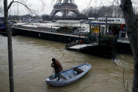 <p>A man uses a small boat to make his way from a houseboat as the Seine River overflows its banks as heavy rains throughout the country have caused flooding, in Paris, France, Jan. 26, 2018. (Photo: Pascal Rossignol/Reuters) </p>