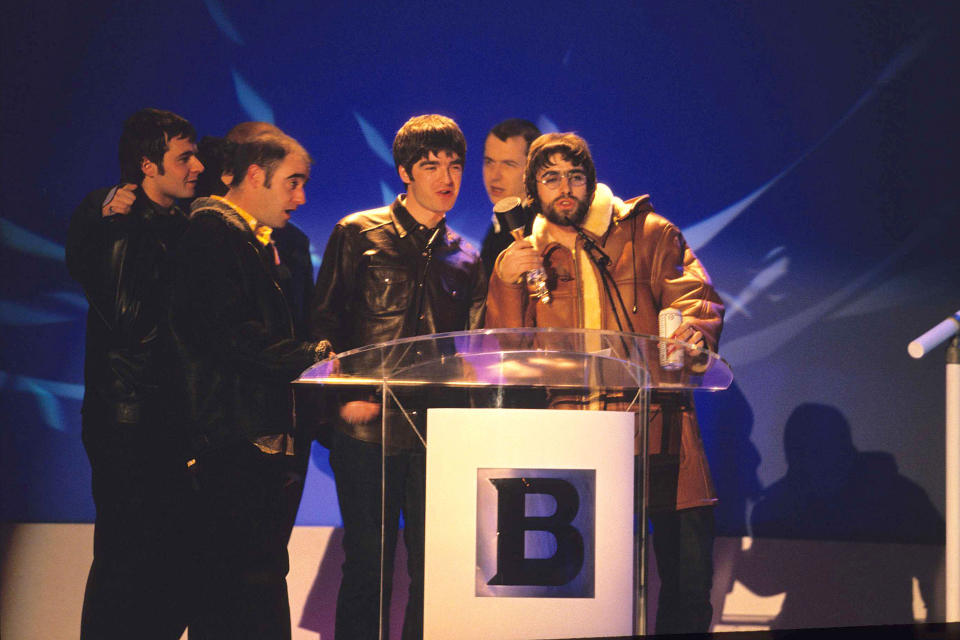 Noel Gallagher, Liam Gallagher and Oasis accepting award at the Brit Awards in 1996 (Photo by Fred Duval/FilmMagic)