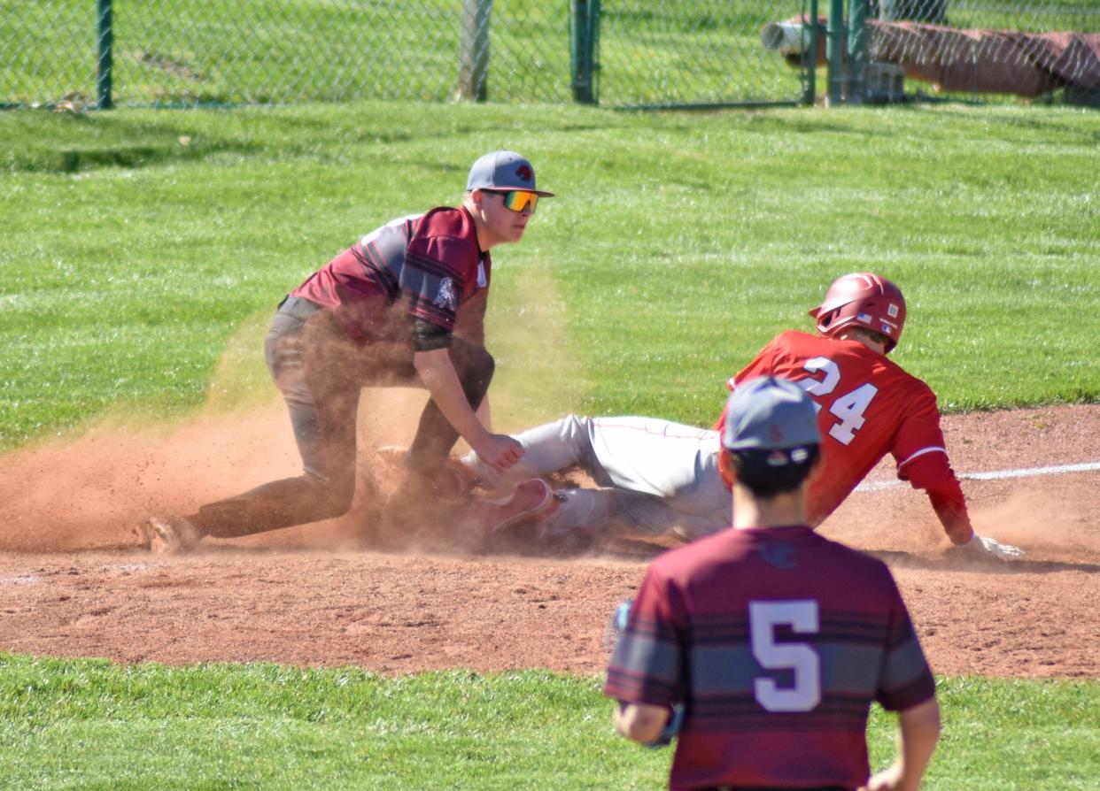 Coldwater's Owen Tappenden (24) slides safely into third while Union City's Eli Payne applies the tag Thursday