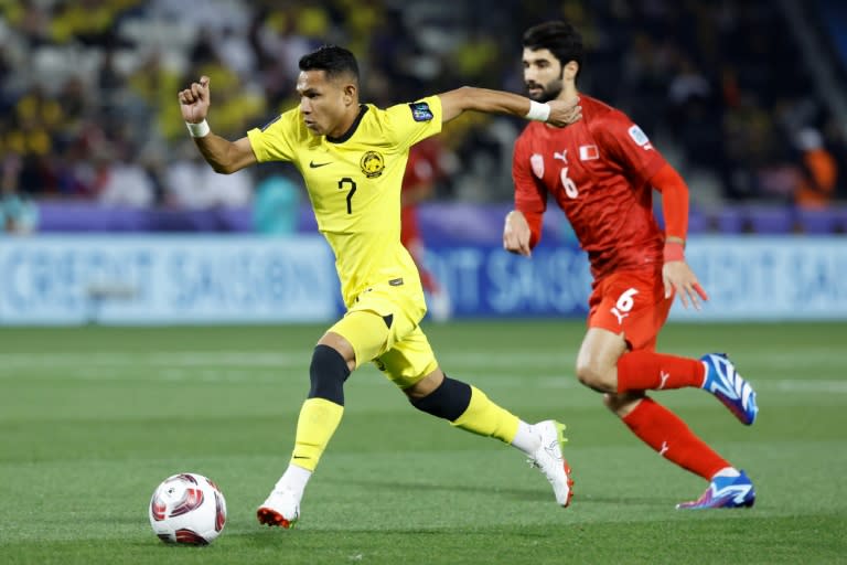 Malaysia's Faisal Halim (L) during the Qatar 2023 AFC Asian Cup Group E football match against Bahrain (KARIM JAAFAR)